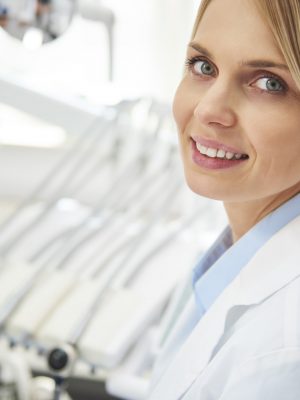 Portrait of smiling female dentist in dentist's office